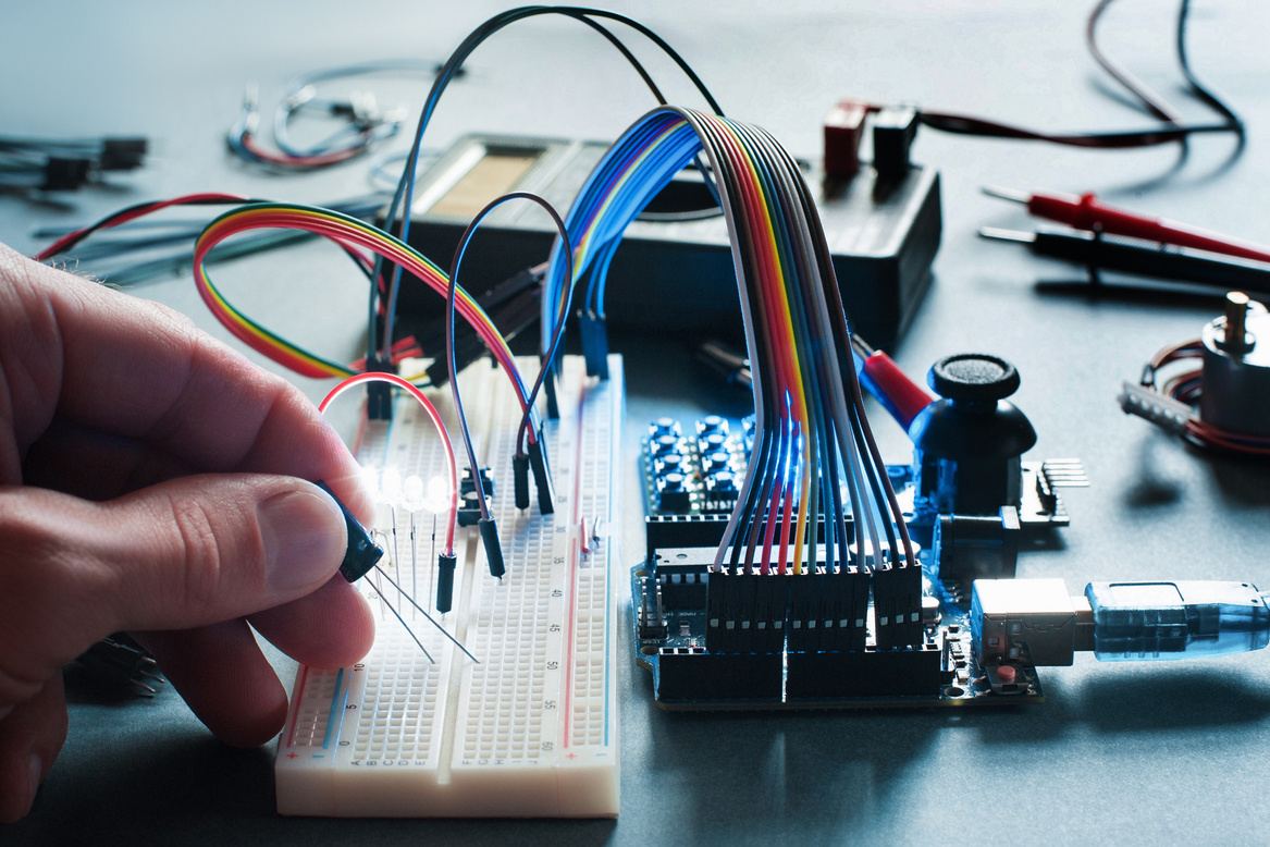 Engineer prototyping a circuit on a breadboard